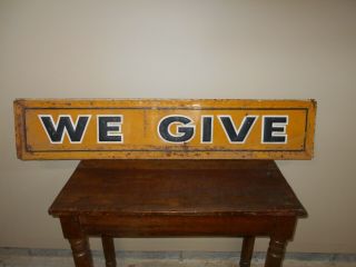 Vintage Metal Sign With Embossed Lettering That Says We Give