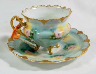 Antique Porcelain 4 footed Demitasse Cup and Saucer with gold trim and handle 2