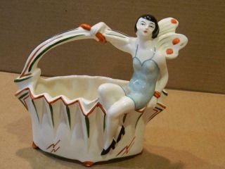 Art Deco Ceramic Figure Of Flapper Girl W/ Butterfly Wings Astride A Basket