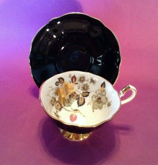 Queen Anne Pedestal Teacup & Saucer - Black With Brilliant Gold Roses - England