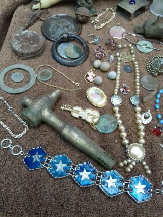 detecting finds,  jewellery,  bits,  coins,  some silver and maybe gold.  Unresearched 3