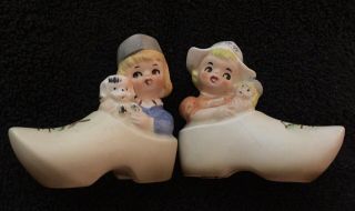Dutch Boy And Girl Sitting Inside Wooden Shoes Salt And Pepper Shakers Vintage