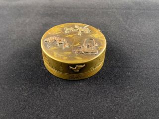 A Japanese 19th C.  bronze circular box and cover with mixed metal 2