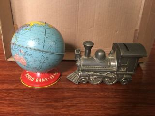 Set Of Two Different,  Vintage Coin Banks.  Tin Globe And Metal Train.  Very Cool