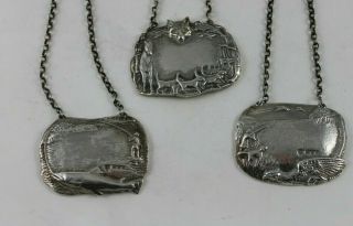 A Set Of 3 Heavy Cast Silver Sporting Wine Labels