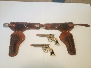 2 Vintage Hubley Texan Jr.  Red Star / Black Bull Grip Cap Guns W/ Holster.  50 