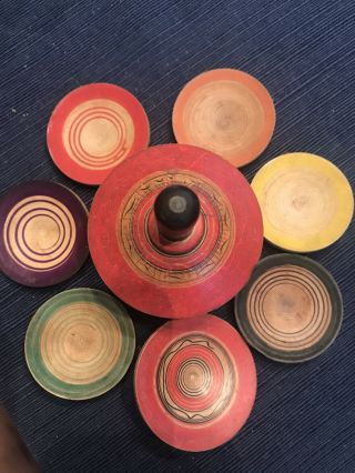 Wooden Spinning Top That Releases 7 Colorful Disks When Spun.