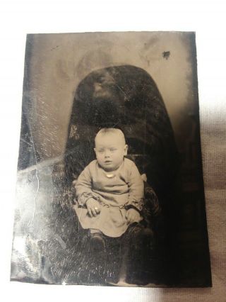Vintage Tin Type Photo Of Baby With A Ghostly Image Of A Man Above The Baby.