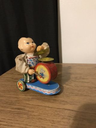 Vintage 1960’s Wind Up Tin Toy Baby Playing Drum And Symbols On Wheels