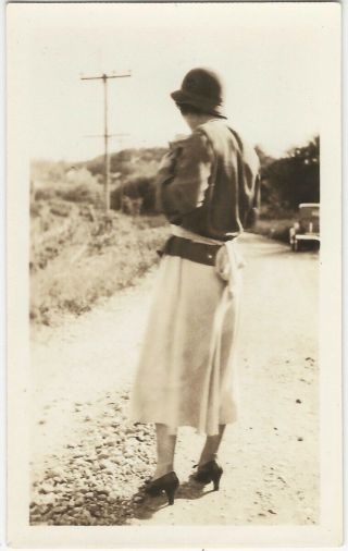 Woman In Hat & High Heels On Roadside With Her Back To Camera Vintage Snapshot