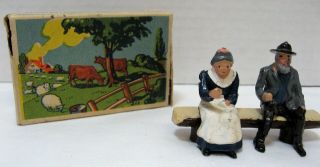 Britains Old Couple Sitting In Bench With Box