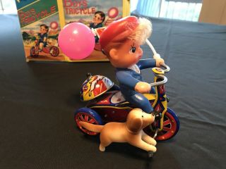 Mtu Mechanical Wind Up Happy Days Boy On Tin Tricycle,  With Balloon,  Dog,  Bell