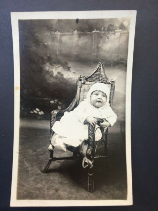 Vintage Black And White Studio Photo Of A Baby In A Wicker Chair 1920s?