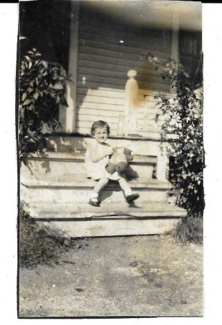 Little Girl With Her Teddy Bear Sitting On Wooden Porch Steps,  1930 