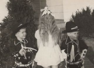 2 little cowboys in Hopalong Cassidy outfits flanking girl seen from back,  50s 2