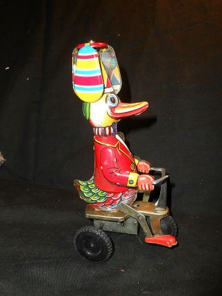 Vintage Wind Up Duck On Bike Trike China Spinning Hat Metal Toy Tin