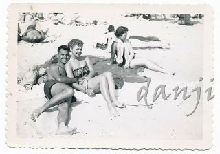 Handsome Swimsuit Couple Cuddling On The Beach With Feet In Camera Old Photo