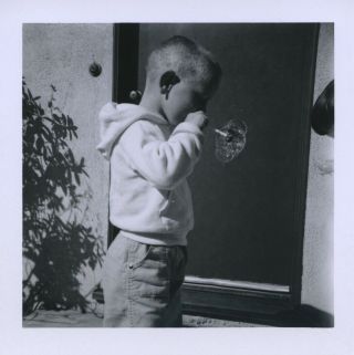 Vintage Photo.  Boy Blowing Soap Bubbles.