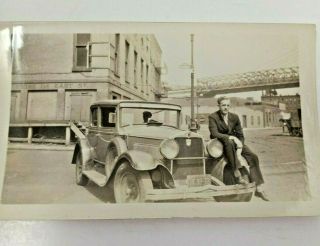 Vintage B&w Photo Of Man On Car On City Street