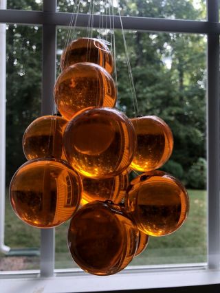 Set Of 14 Vintage Mid Century Amber/orange Lucite Balls With Hanger