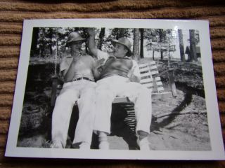 Vintage Black And White Photo Of 2 Men Sitting On Swing While Smoking Cigars