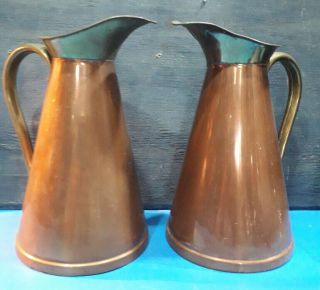 A Set Of Two Copper And Brass Vintage Jugs