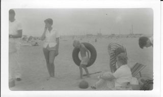 1455p Vintage Photo Young Boy Carrying Tire Innertube At The Beach By Mom