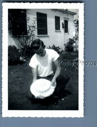 Found B&w Photo F,  4414 Man Posed Crouching Holding Cake
