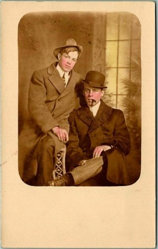 Vintage 1910s Rppc Studio Photo Postcard Two Young Men Hats,  Smoking Cigars