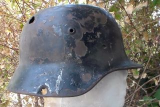 Old Ww2 German Military Helmet With Bullet Holes By A Motorcycle Biker Gang