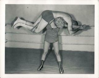 Female Wrestler Holding Man Across Shoulders Photograph