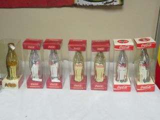 7 Coca Cola Brand Commemorative Bottles Gold & Silver 1 Crackle Barrel
