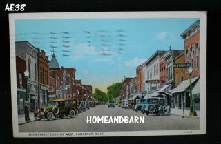 Old 1928 Postcard Conneaut Ohio Main Street Looking West Downtown Stores Old Car