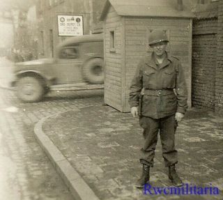 Great Helmeted Us Soldier By Light Truck On German Street By Depot Signpost
