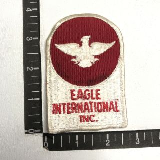 Vtg As - Is - Stain Eagle International Inc.  (? Bus Manufacturer ?) Ad Patch 80b9