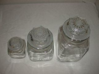 SET OF THREE ANCHOR HOCKING SQUARE CANISTER JARS WITH STARBURST LIDS AND SEALS 2
