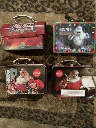 4 Collectable Minature Coca Cola Santa Lunch Boxes.  Appox 4” Boxes All