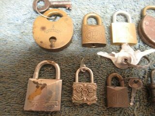 10 different old miniature padlock lock.  2 are combination.  3 with a key.  n/r 2