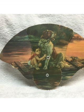 Antique Fan With Small Boy And Dog On A Raft In The Water.