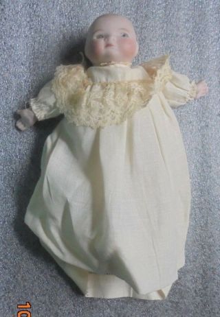 Small Antique Bisque Head Baby Doll In Clothing