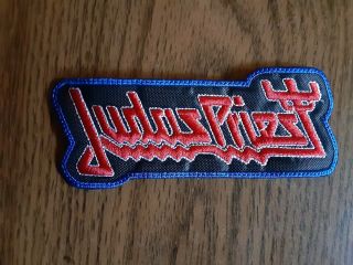 Judas Priest,  Sew On Red And White With Blue Edge Embroidered Patch