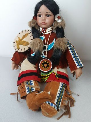 Native American Porcelain Sitting Female Doll Dressed In Her Native Clothing