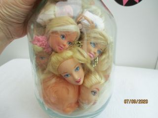 A Large Jar Of Vintage Doll Heads.