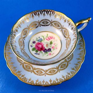 Gold Design On Blue Background With Floral Center Paragon Tea Cup And Saucer Set
