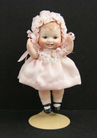 Vintage Porcelain Doll In Pink Outfit On A Stand