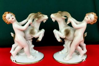 2 German Erphila Porcelain Boys Grabbing A Billy Goat Ram By The Horns Figurine