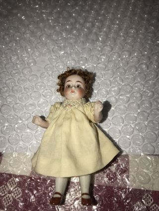 Antique All Bisque 4” Doll.  Brown Glass Eyes.  Marked 161 - 9
