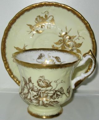 Paragon Gold Flowers On Pale Yellow Scalloped Tea Cup And Saucer